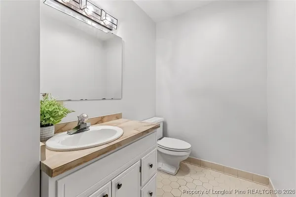 a bathroom with a sink toilet and a mirror