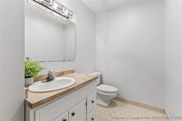 a bathroom with a sink toilet and a mirror