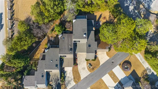 an aerial view of a house with a yard basket ball court and outdoor seating