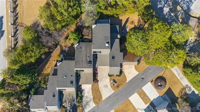 an aerial view of a house with a yard basket ball court and outdoor seating