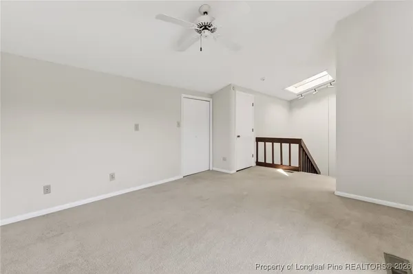 a view of a livingroom with a ceiling fan and window