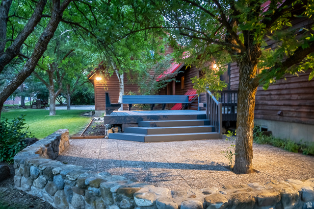 435 Canyon Road Millville, UT 84326 - Photo 65 of 113 Expansive outdoor patio area featuring a stone retaining wall and a multi-level deck constructed with composite materials