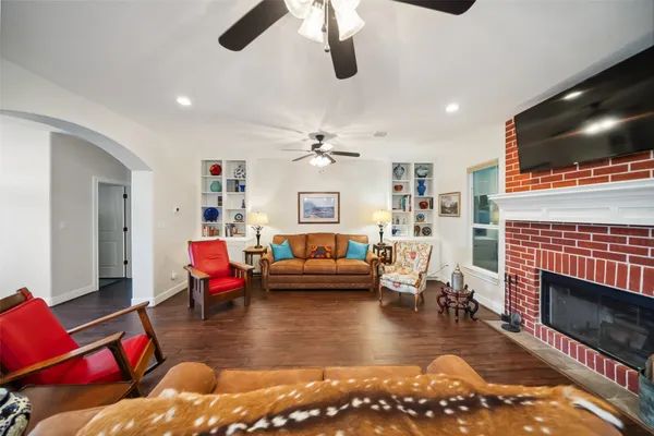 a living room with furniture and wooden floor