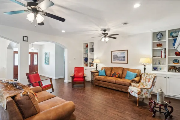 a spacious bedroom with a bed and a chandelier