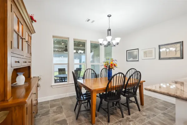 a view of cabinets and utility room with window