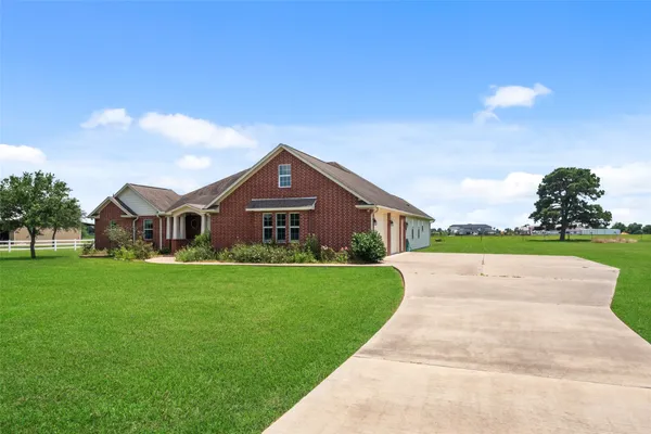 a view of a hallway with a dining table and chandelier
