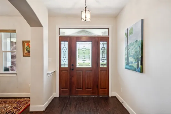 a living room with furniture a fireplace and a chandelier