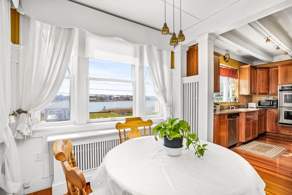 75 Surfside Road Scituate, MA 02066 - Photo 11 of 25 a dining room with stainless steel appliances furniture a window and a kitchen view
