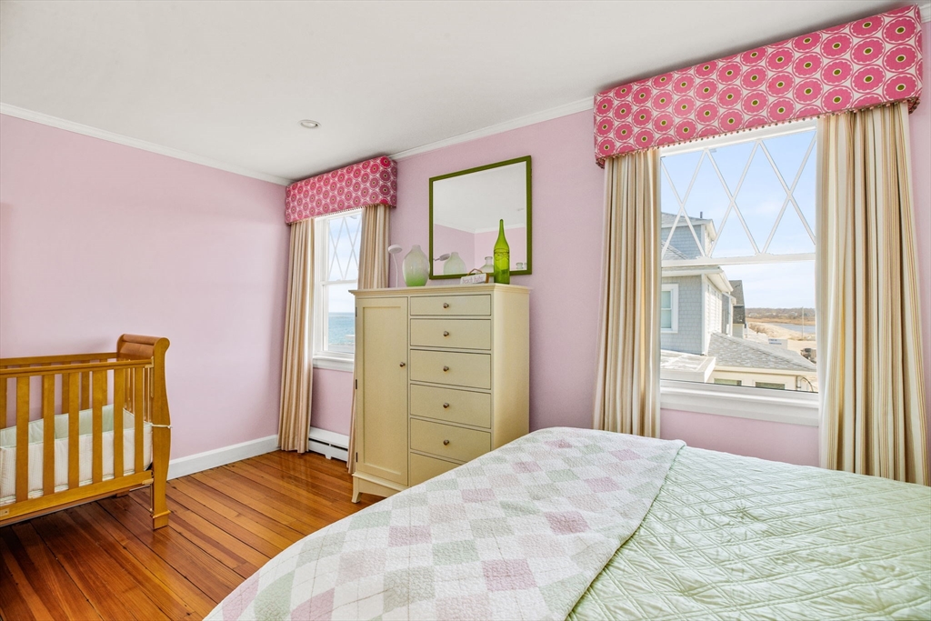 75 Surfside Road Scituate, MA 02066 - Photo 12 of 25 a bedroom with a bed and wooden floor
