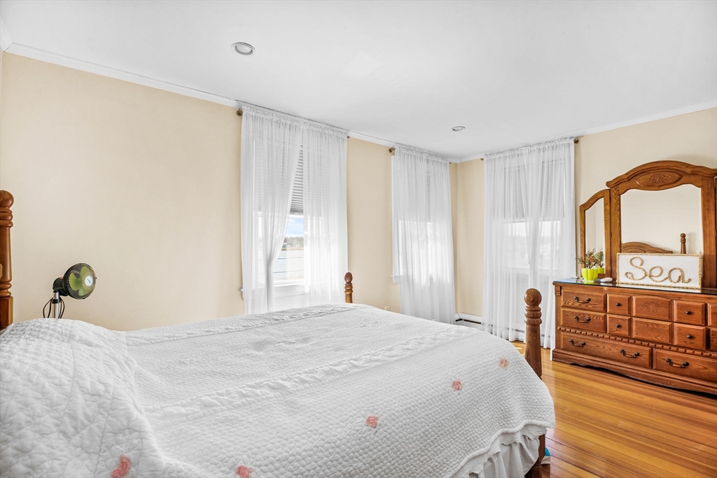 75 Surfside Road Scituate, MA 02066 - Photo 14 of 25 a bedroom with a bed and wooden floor