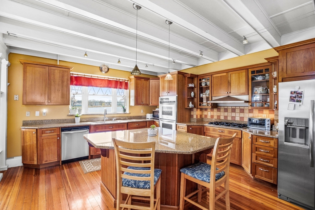 75 Surfside Road Scituate, MA 02066 - Photo 10 of 25 a kitchen with stainless steel appliances granite countertop a sink and cabinets