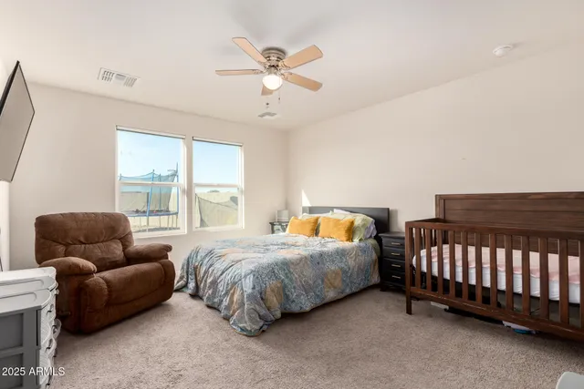 a bedroom with bed and a window