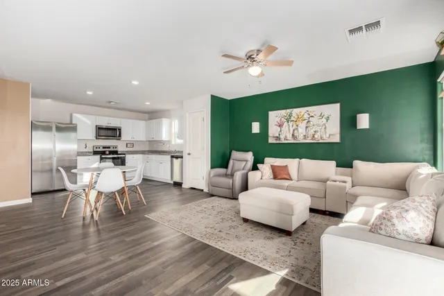 a living room with furniture and kitchen view