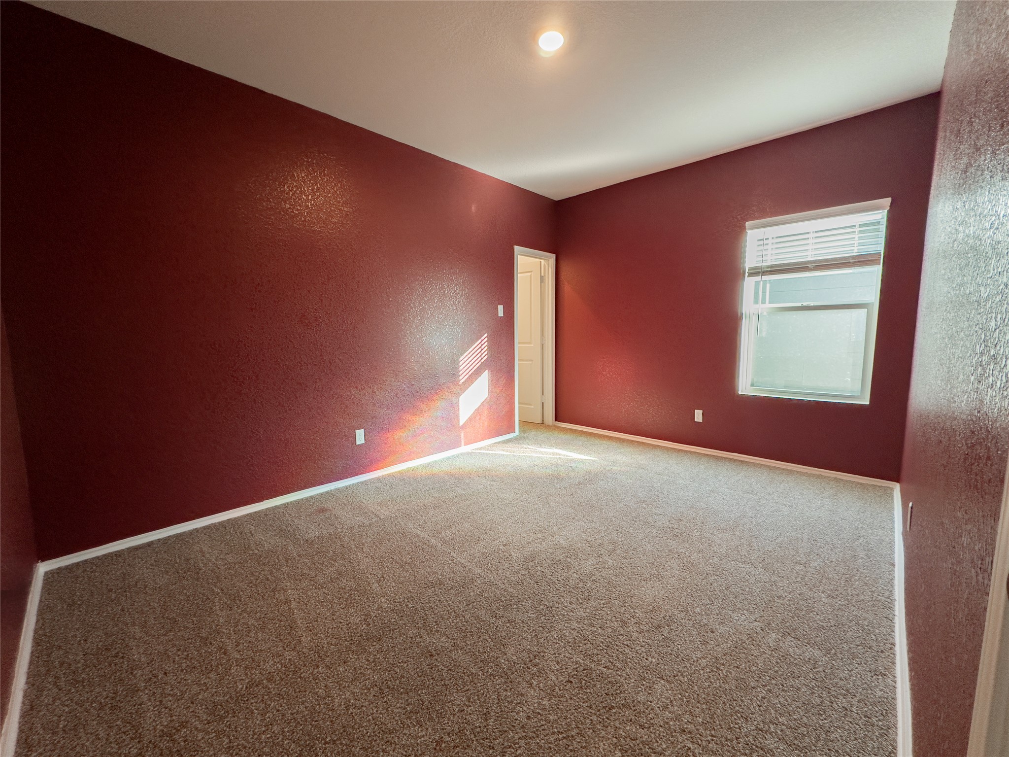 312 Soapstone Pass Maxwell, TX 78656 - Photo 12 of 21 Room featuring rich red walls and neutral-toned carpeting