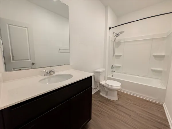 a bathroom with a sink toilet a mirror and shower