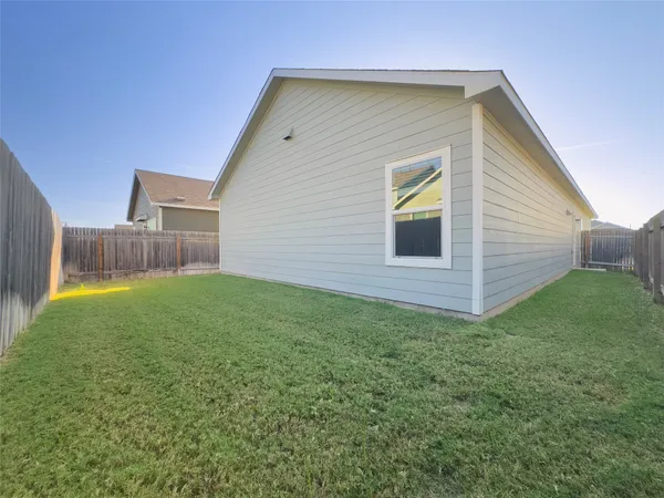a view of a backyard of the house