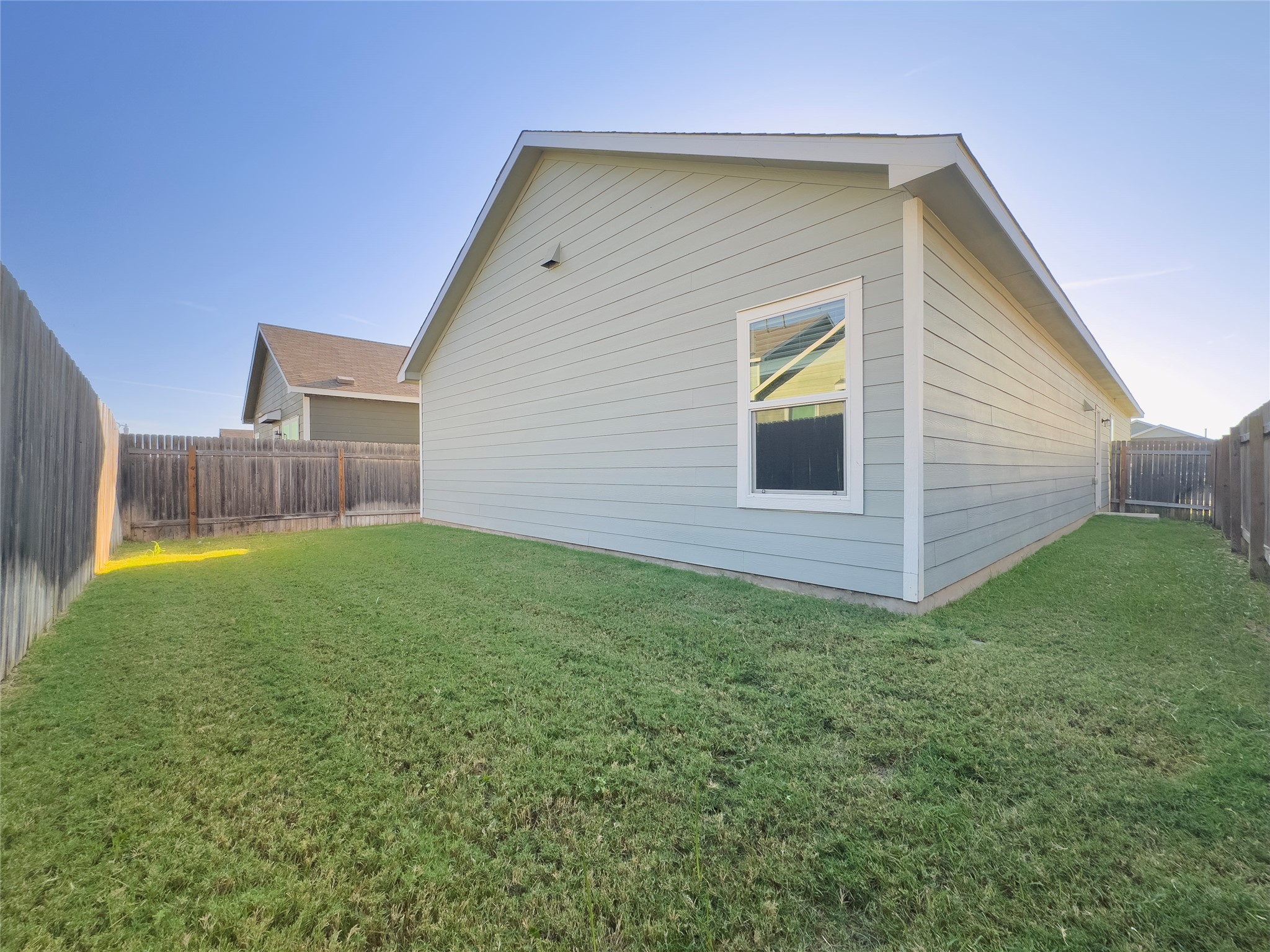 312 Soapstone Pass Maxwell, TX 78656 - Photo 20 of 21 Expansive side yard featuring a lush lawn and wood privacy fencing
