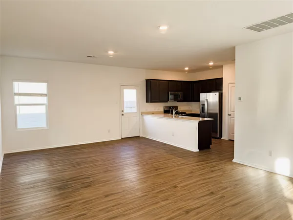 a view of kitchen with microwave and cabinets