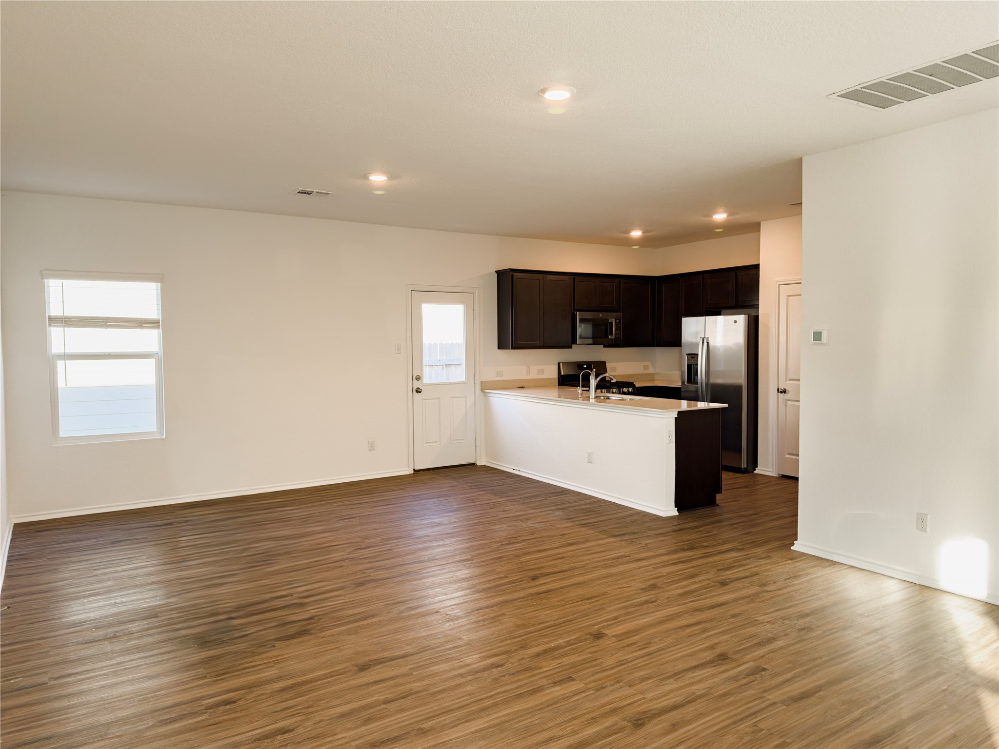 312 Soapstone Pass Maxwell, TX 78656 - Photo 2 of 21 Open-concept common area featuring wood-finish flooring throughout