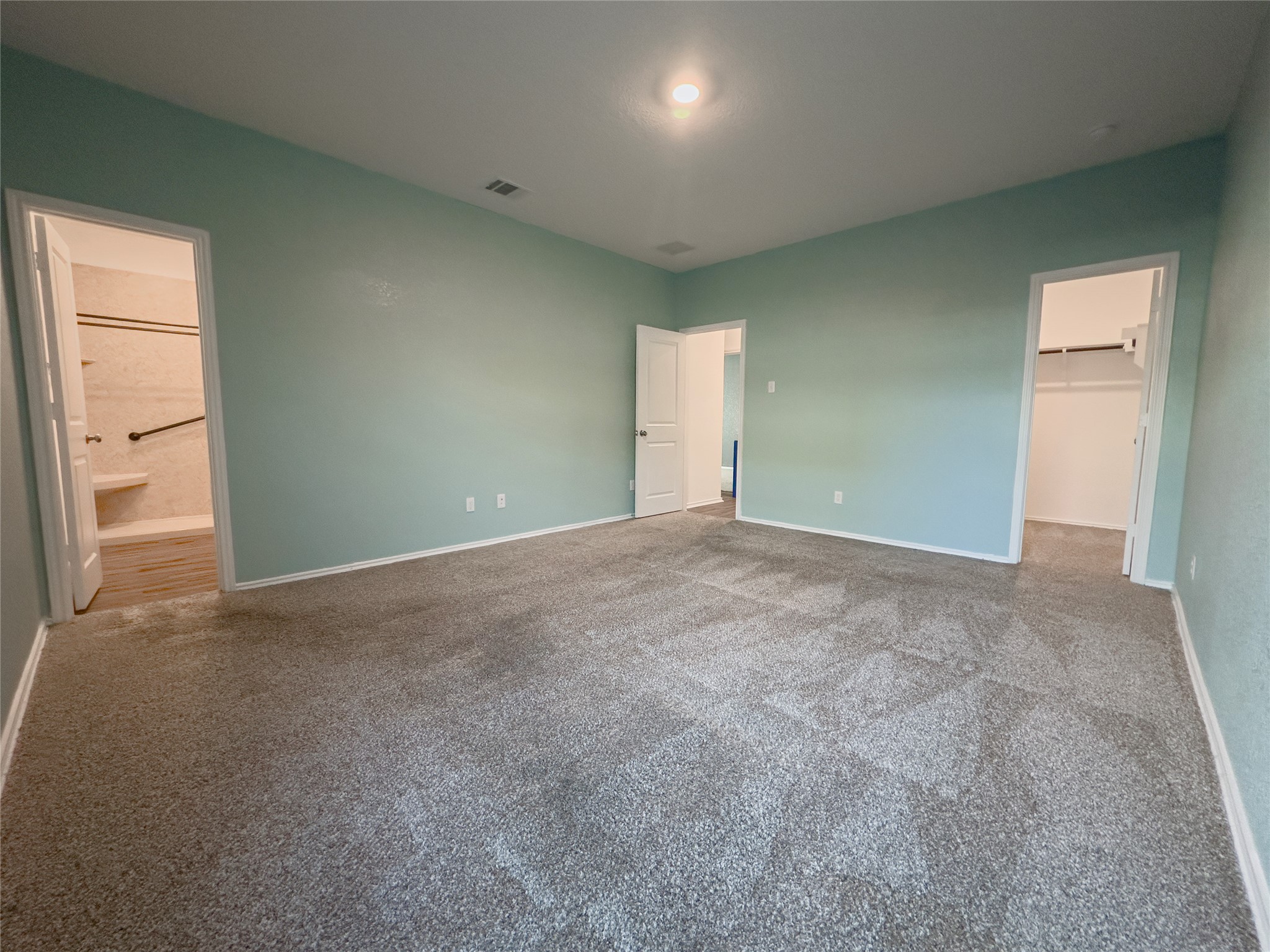 312 Soapstone Pass Maxwell, TX 78656 - Photo 7 of 21 Spacious room featuring light blue walls, gray carpeting, and a vaulted ceiling