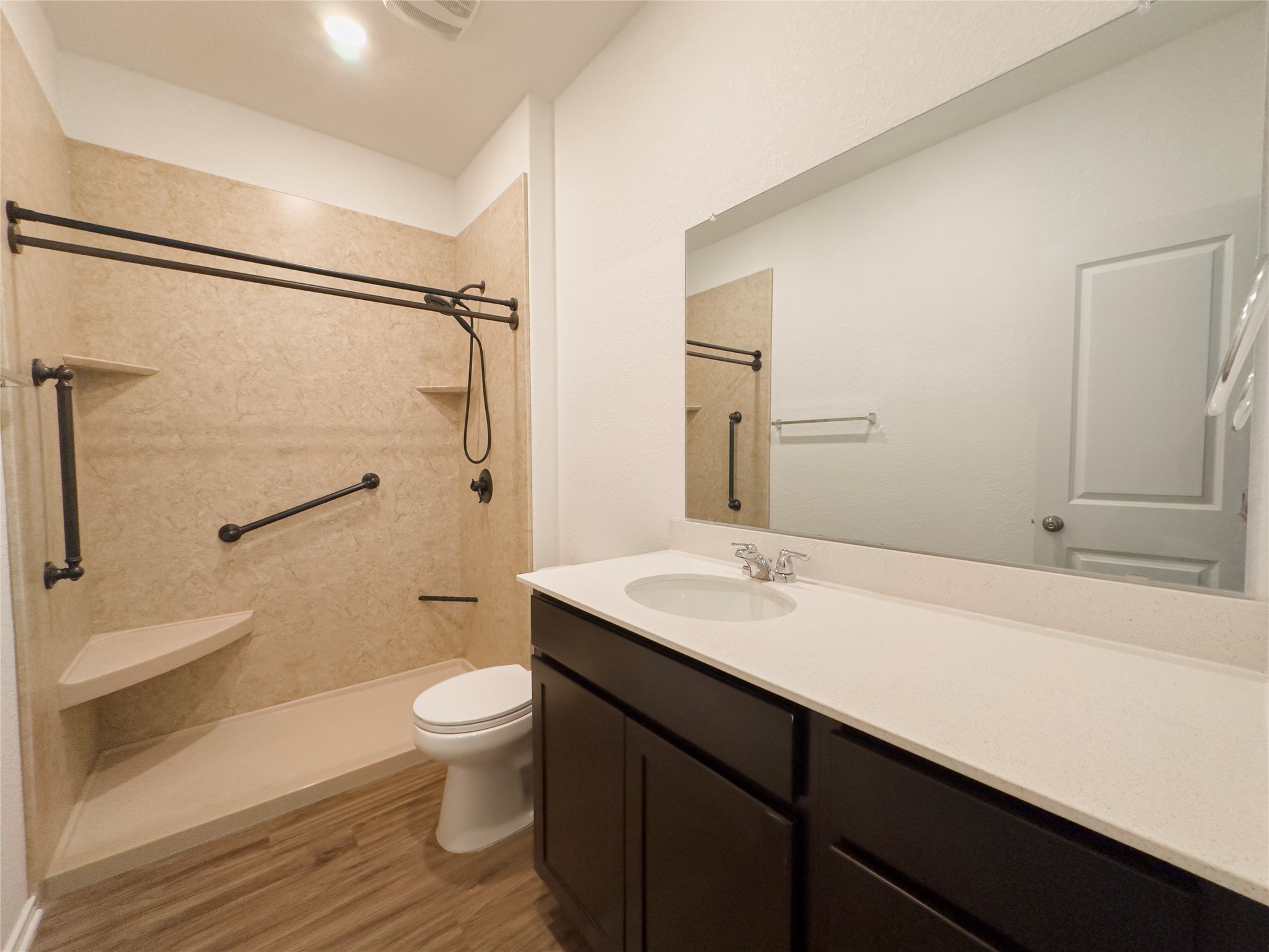 312 Soapstone Pass Maxwell, TX 78656 - Photo 10 of 21 Bathroom featuring a walk-in shower with integrated corner shelving and grab bars