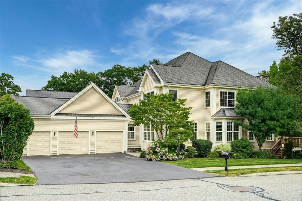47 Clubhouse Way, Unit 47 Sutton, MA 01590 - Photo 1 of 30 a front view of a house with a yard and garage
