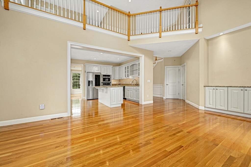 47 Clubhouse Way, Unit 47 Sutton, MA 01590 - Photo 11 of 30 a view of empty room with wooden floor and kitchen view