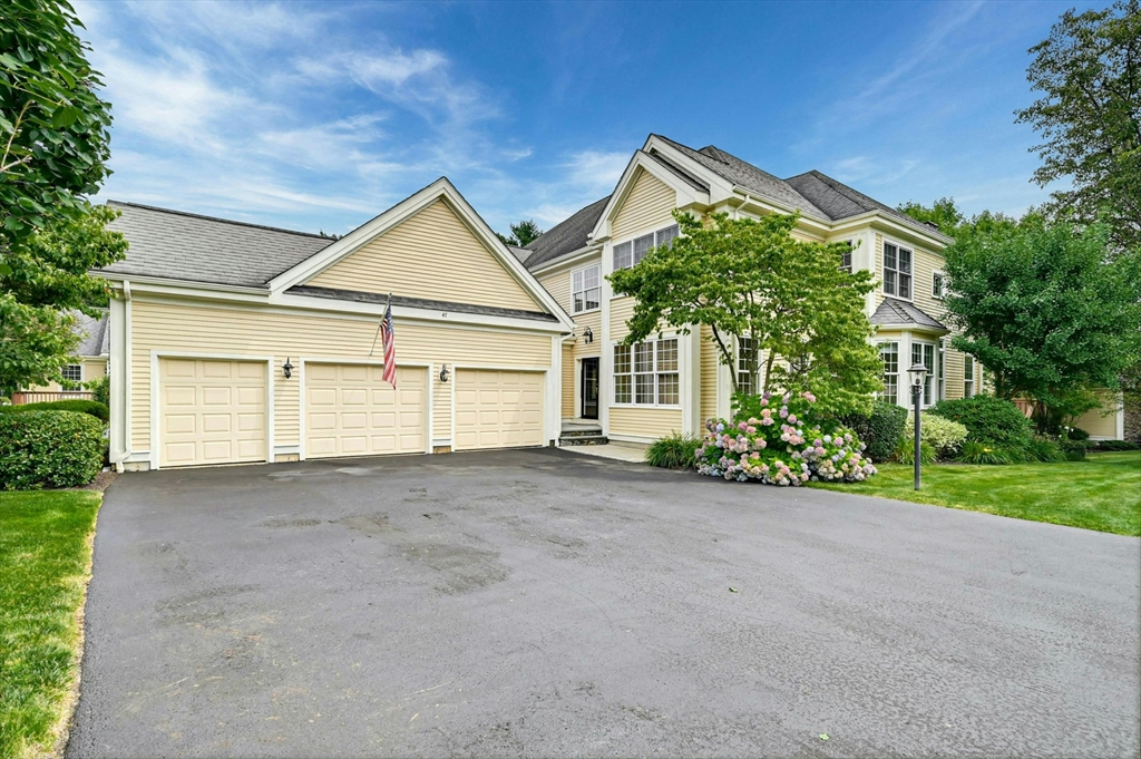 47 Clubhouse Way, Unit 47 Sutton, MA 01590 - Photo 2 of 30 a view of a house with a yard and garage