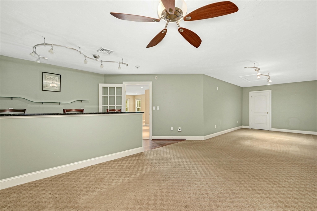 47 Clubhouse Way, Unit 47 Sutton, MA 01590 - Photo 21 of 30 a view of an empty room with window and a kitchen