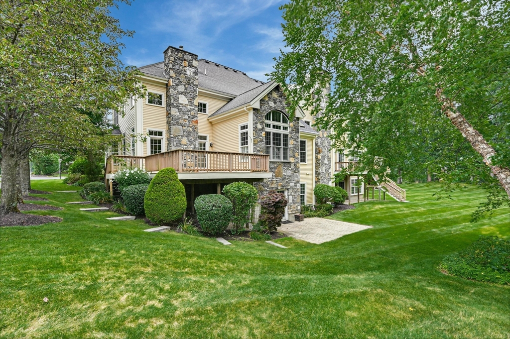 47 Clubhouse Way, Unit 47 Sutton, MA 01590 - Photo 25 of 30 a view of a house with a big yard potted plants and large tree