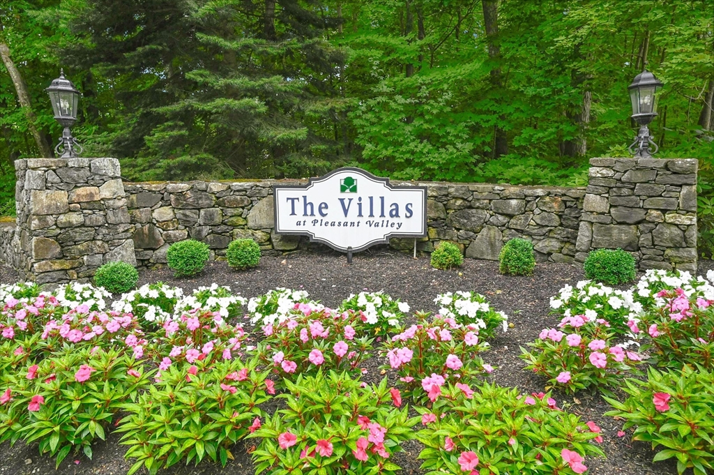 47 Clubhouse Way, Unit 47 Sutton, MA 01590 - Photo 26 of 30 a sign that is sitting in the middle of flowers