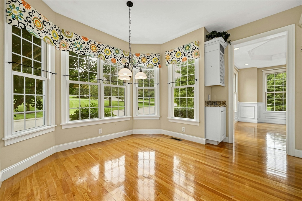 47 Clubhouse Way, Unit 47 Sutton, MA 01590 - Photo 6 of 30 a view of an empty room with a window and wooden floor