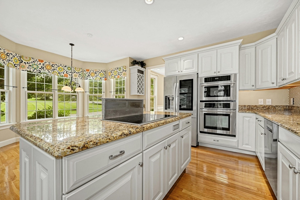 47 Clubhouse Way, Unit 47 Sutton, MA 01590 - Photo 7 of 30 a kitchen with stainless steel appliances granite countertop a stove and a sink
