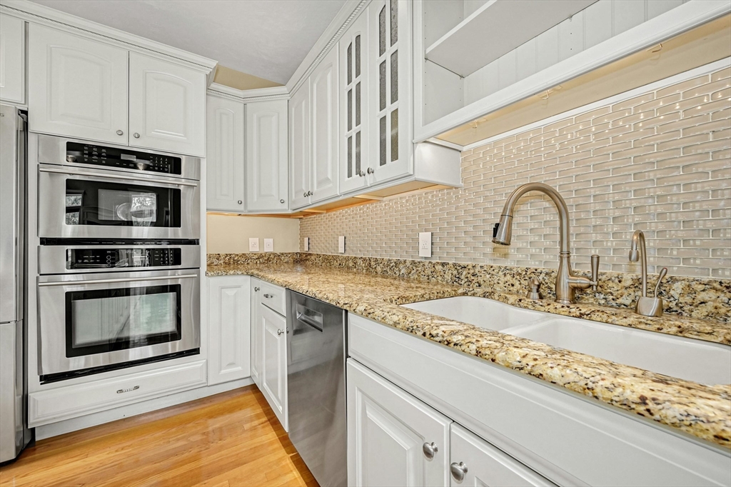 47 Clubhouse Way, Unit 47 Sutton, MA 01590 - Photo 8 of 30 a kitchen with granite countertop a stove and a sink