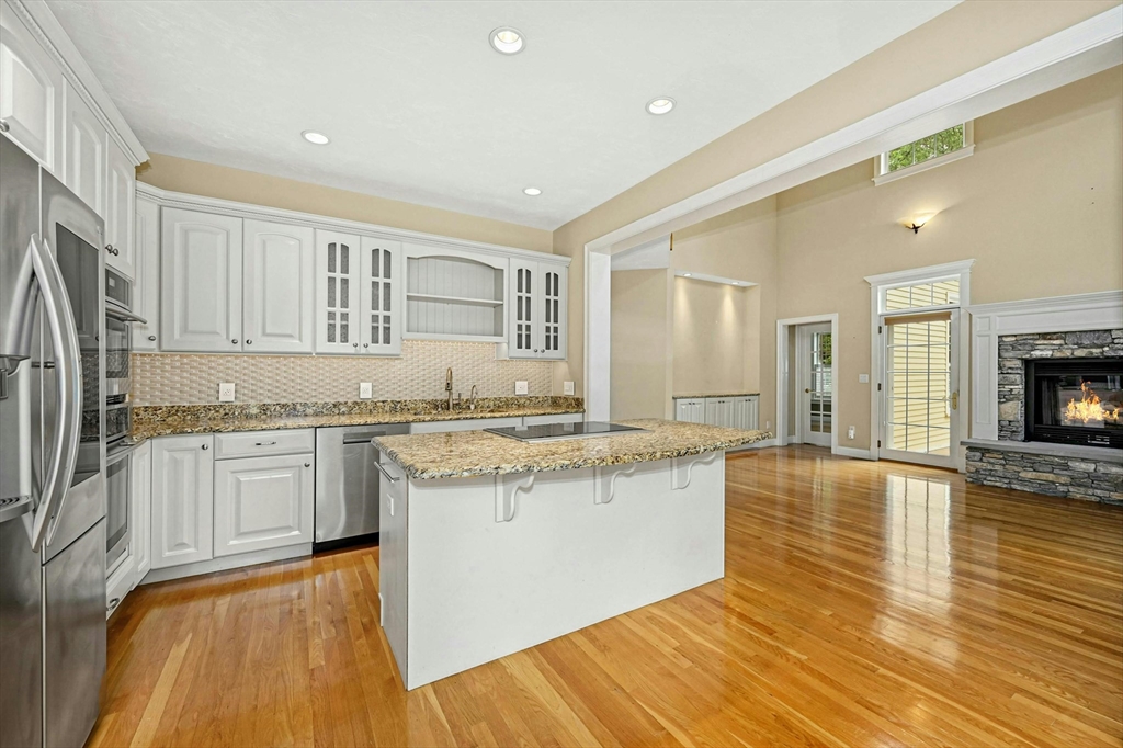 47 Clubhouse Way, Unit 47 Sutton, MA 01590 - Photo 9 of 30 a large kitchen with granite countertop a stove top oven a sink a counter space and cabinets