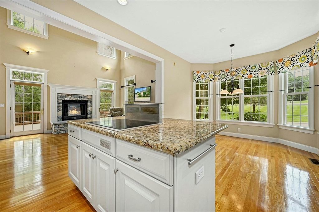 47 Clubhouse Way, Unit 47 Sutton, MA 01590 - Photo 10 of 30 a open kitchen with granite countertop a sink stove and cabinets