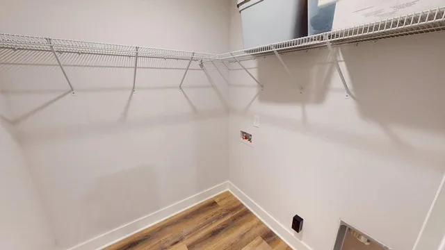 a view of a hallway to a livingroom with furniture