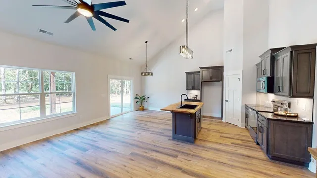 a kitchen view with wooden floor and electronic appliances
