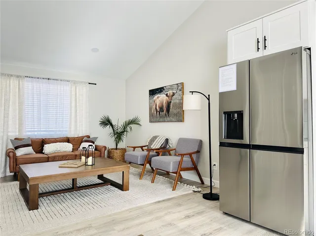 a living room with furniture wooden floor and a table