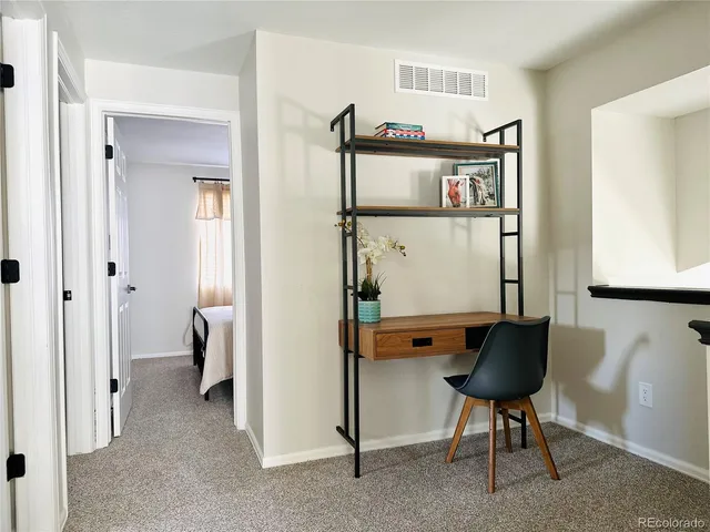 a view of a hallway with couch and a bookshelf
