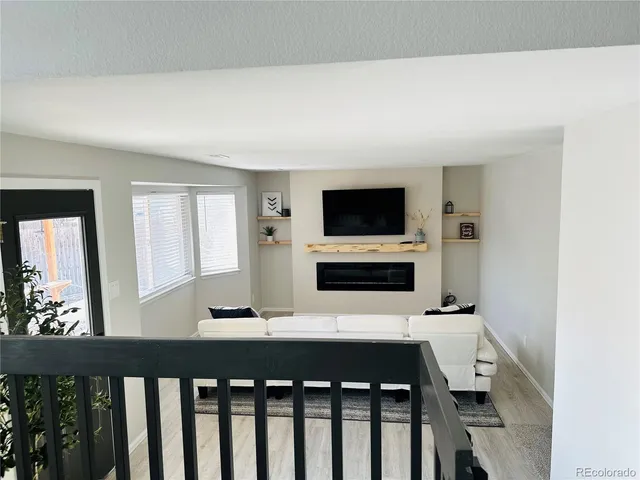 a room with a flat screen tv and a fireplace