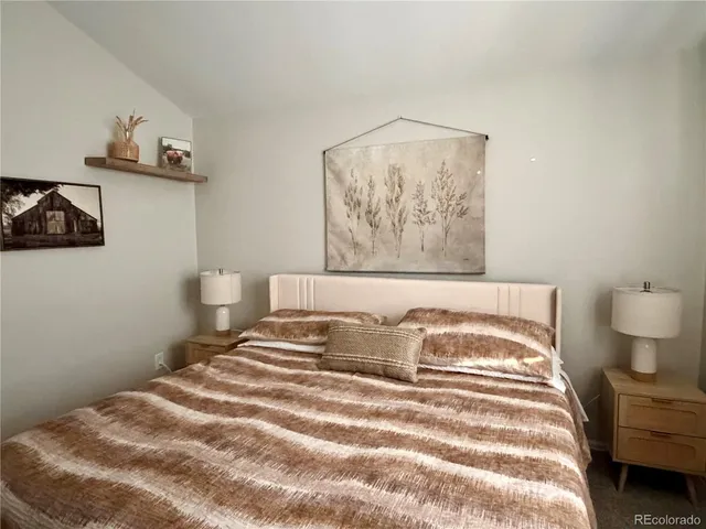 a bedroom with a bed and wall painting