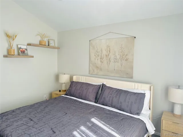 a living room with a couch and a potted plant on it