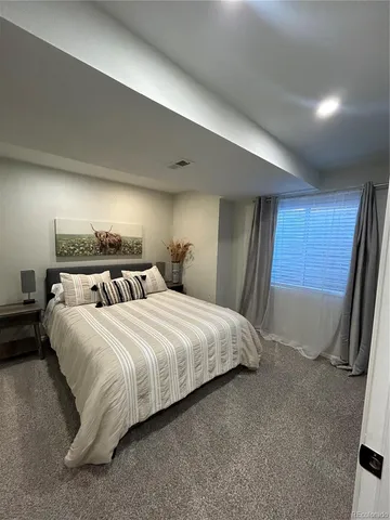 a bedroom with bed and window