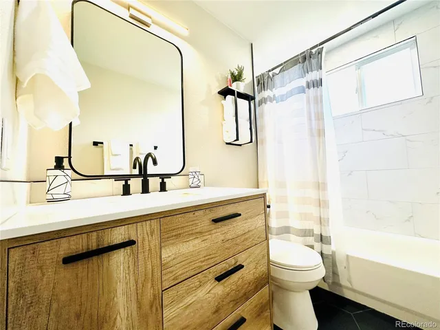 a bathroom with a double vanity sink toilet and shower