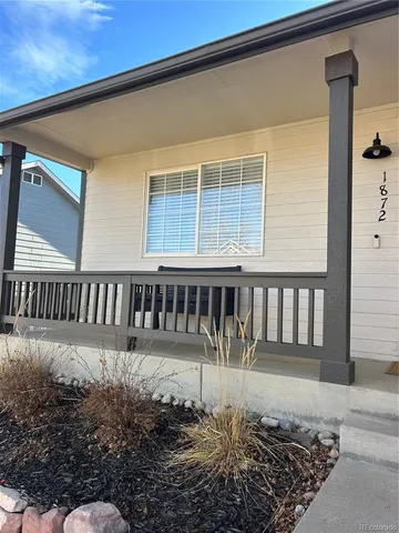 front view of a house with a bench