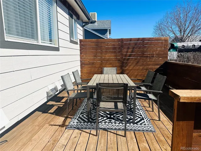 a view of balcony with a table and chairs