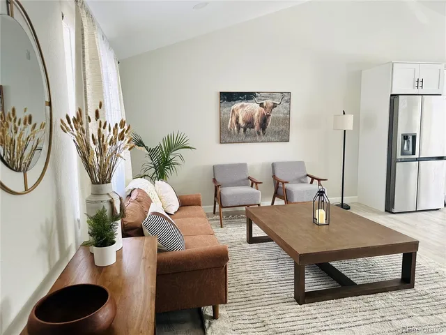 a living room with furniture and a potted plant