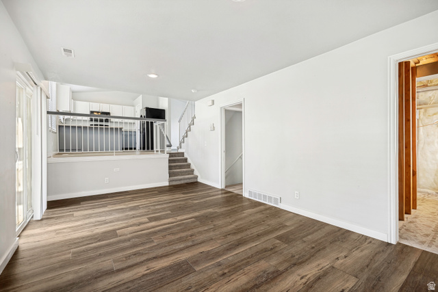 5529 Ridge Hollow Way Kearns, UT 84118 - Photo 10 of 23 Expansive living area with wood-finish flooring, white walls, and recessed lighting