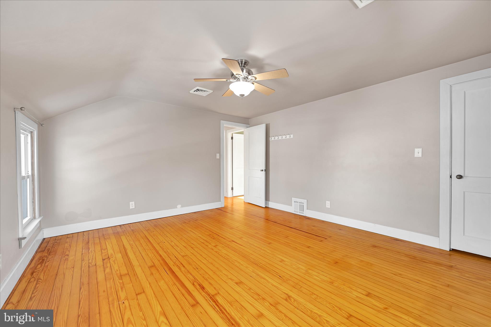 104 Locust Street Annville, PA 17003 - Photo 21 of 43 a view of an empty room with wooden floor and a ceiling fan